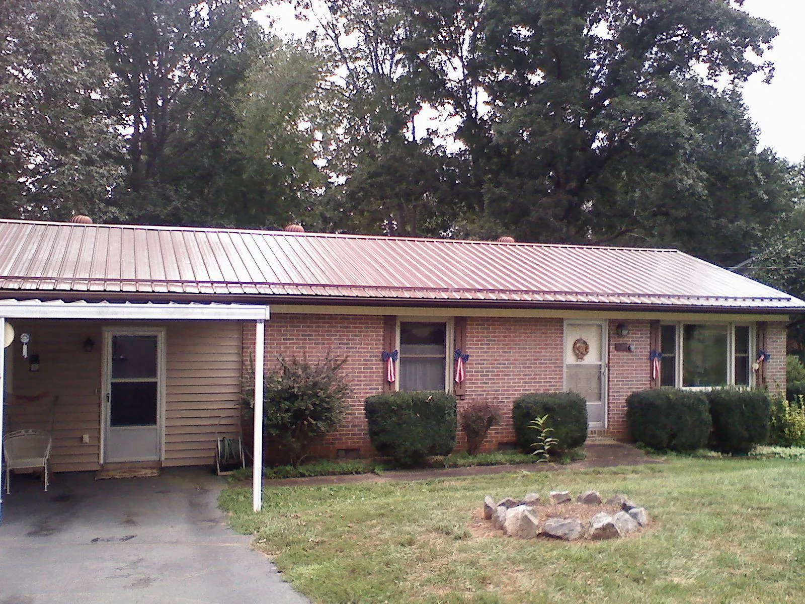 Bronze metal roof and carport on a brick ranch home — Roof Repair work by our crew in Seabeck